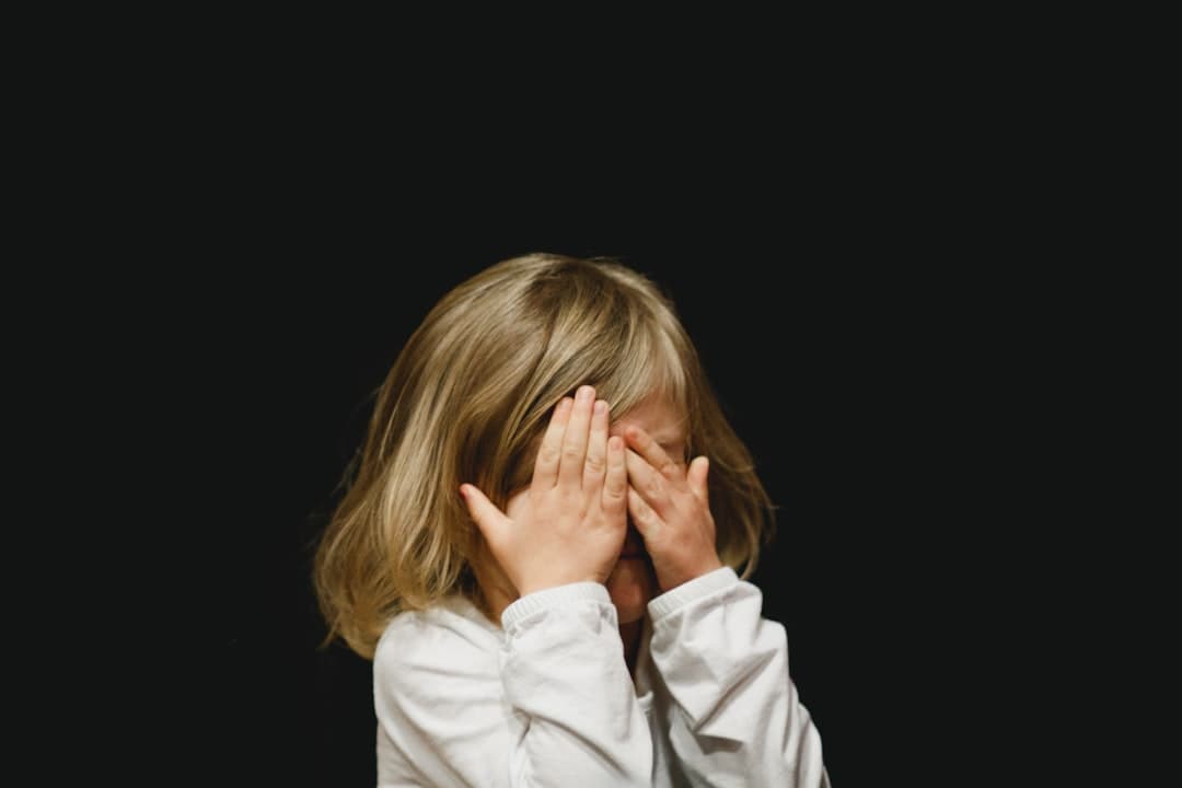 girl covering her face with both hands — Photo by Caleb Woods on Unsplash